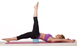 Increase the challenge of your core exercises by placing a brick underneath the pelvis.