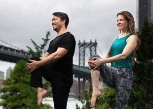Dr. Erich Anderer and Ariel Kiley in a standing knee to chest pose in Brooklyn New York